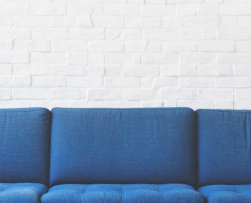 Blue couch with white wall